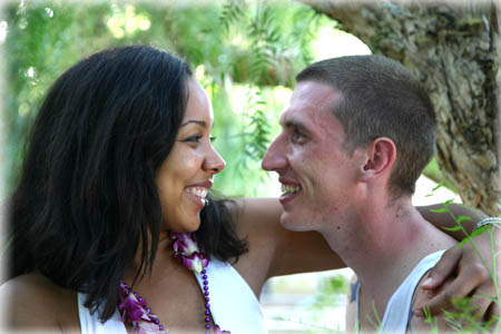 Engaged couple under tree